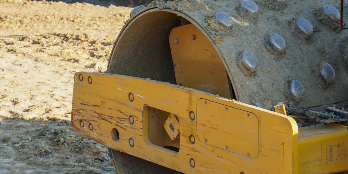 Padfoot roller compacting soil on a construction site